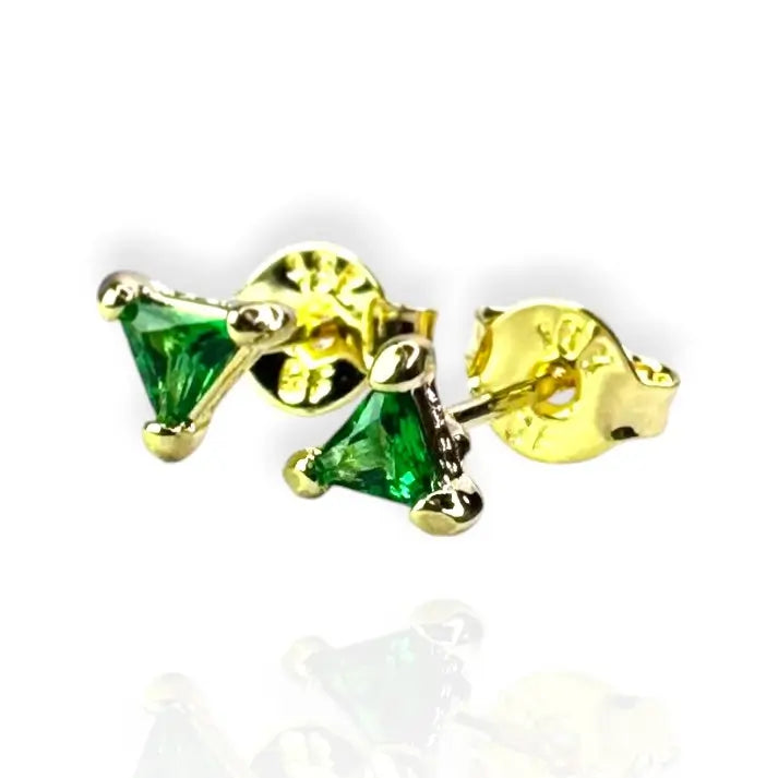 A pair of emerald green stud earrings set in a gold-colored mounting, displayed against a white background.