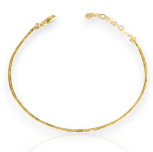 gold herringbone anklet on white background
