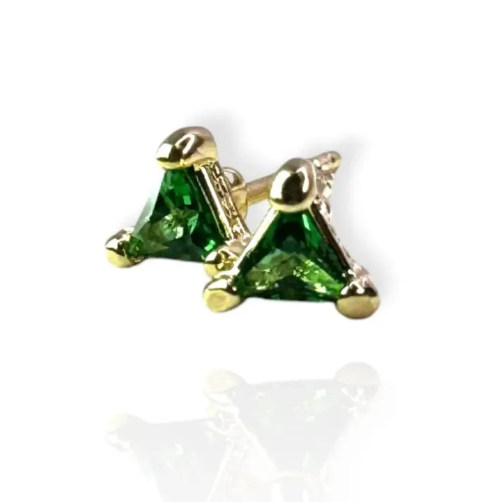 A pair of emerald green stud earrings set in a gold-colored mounting, displayed against a white background.