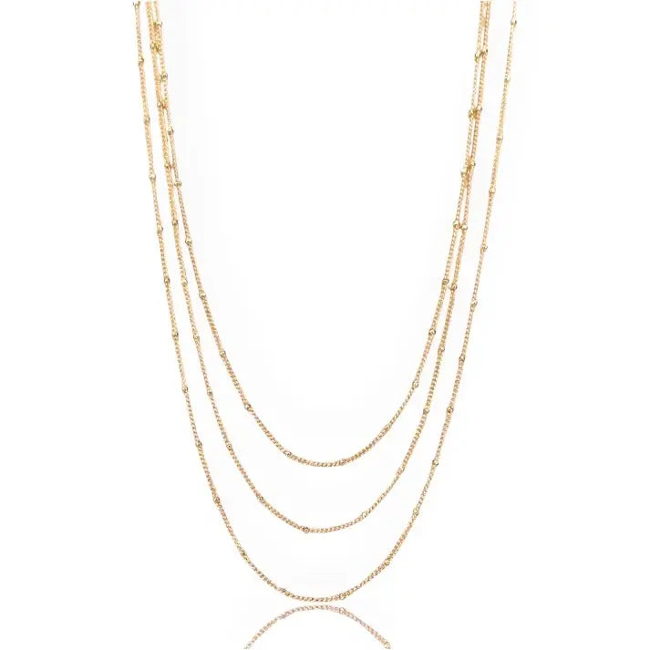 Gold necklace with multiple lengeths on a white background