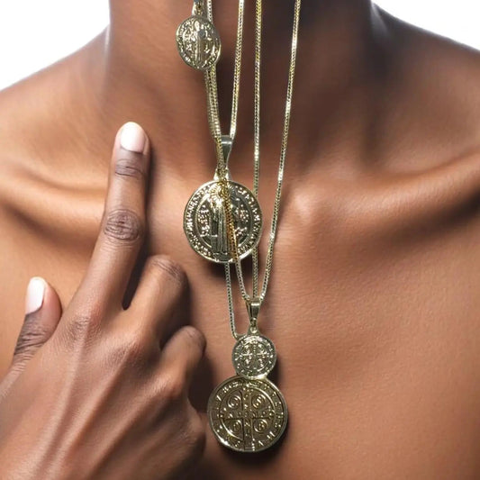 Gold necklace with circular pendants on a person's neck