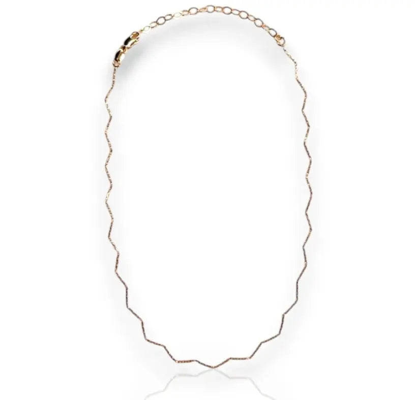 A gold-filled chain necklace with a zigzag design, displayed against a white background.