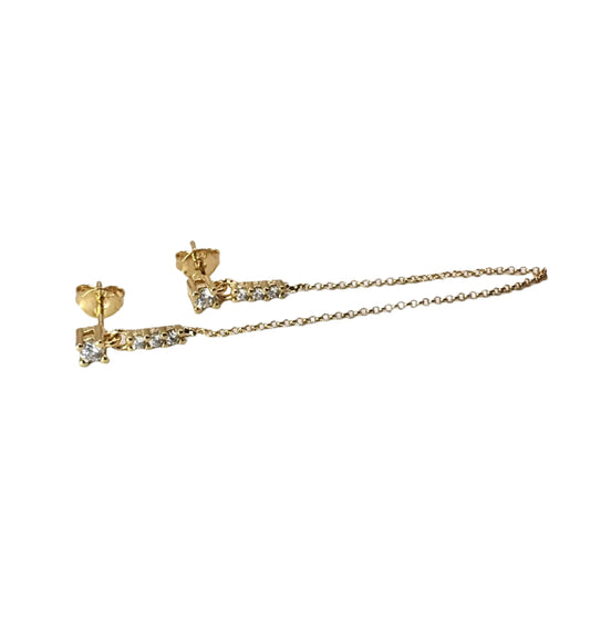 Gold earrings with chain extensions on a white background