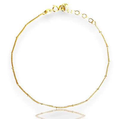 A gold-filled satellite anklet with adjustable clasp and sparkling beads.