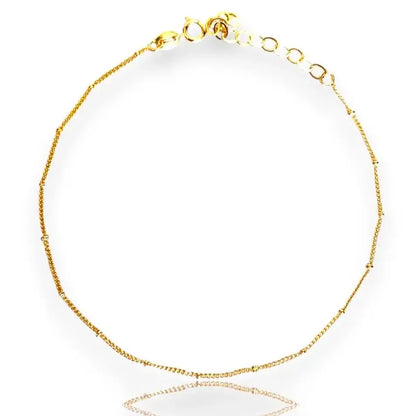 A gold-filled satellite anklet with adjustable clasp and sparkling beads.