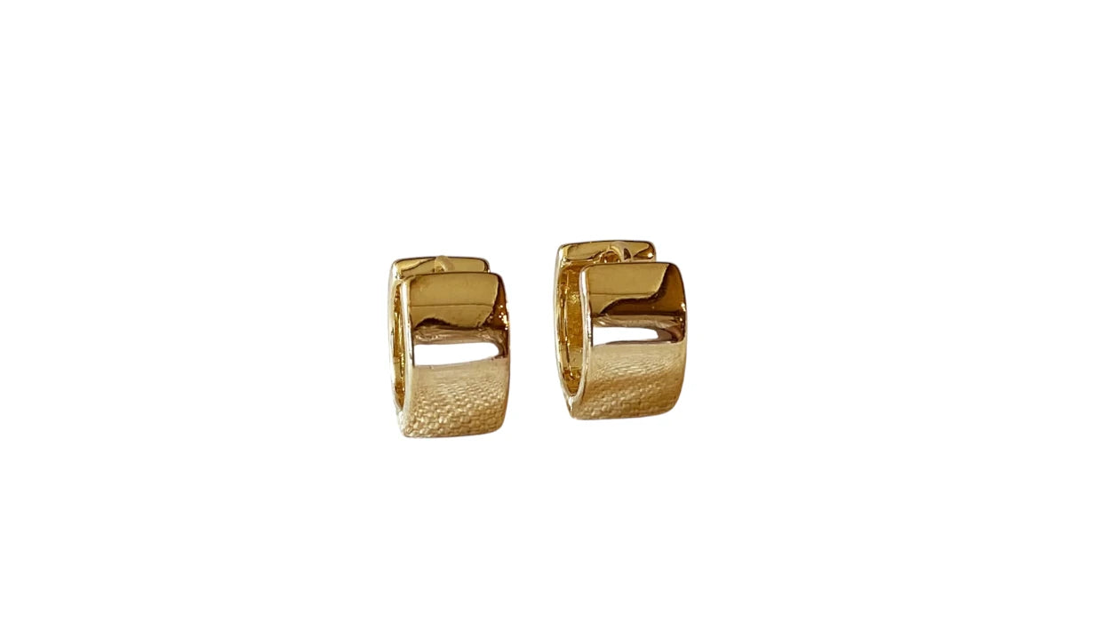 Gold hoop earrings on a white background