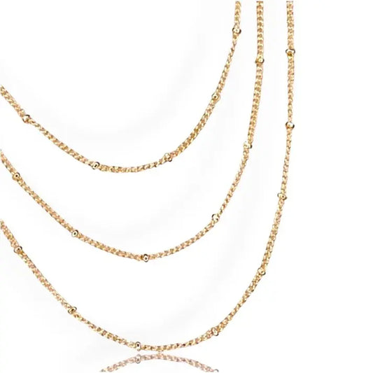 three gold satellite chain necklaces on a white background