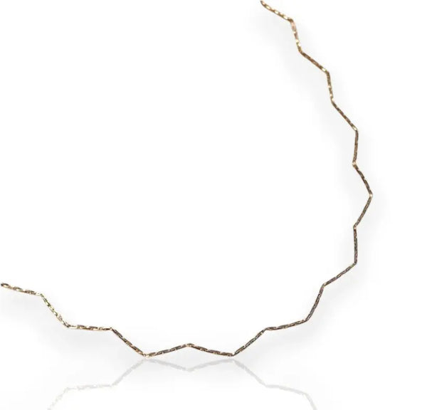 A gold-filled chain necklace with a zigzag design, displayed against a white background.